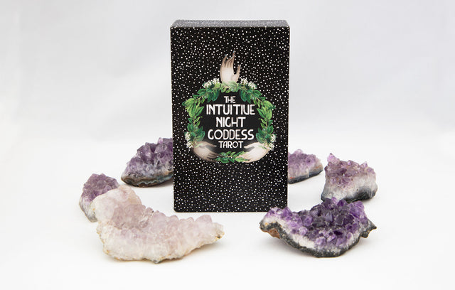 The Intuitive Night Goddess Tarot deck box with amethyst crystals around it