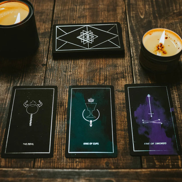 A spread of Synesthesia Tarot cards with two candles